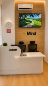 Area pendaftaran InMind Mental Health Clinic dengan desain modern, meja resepsionis, logo InMind, dan suasana klinik kesehatan mental yang hangat.